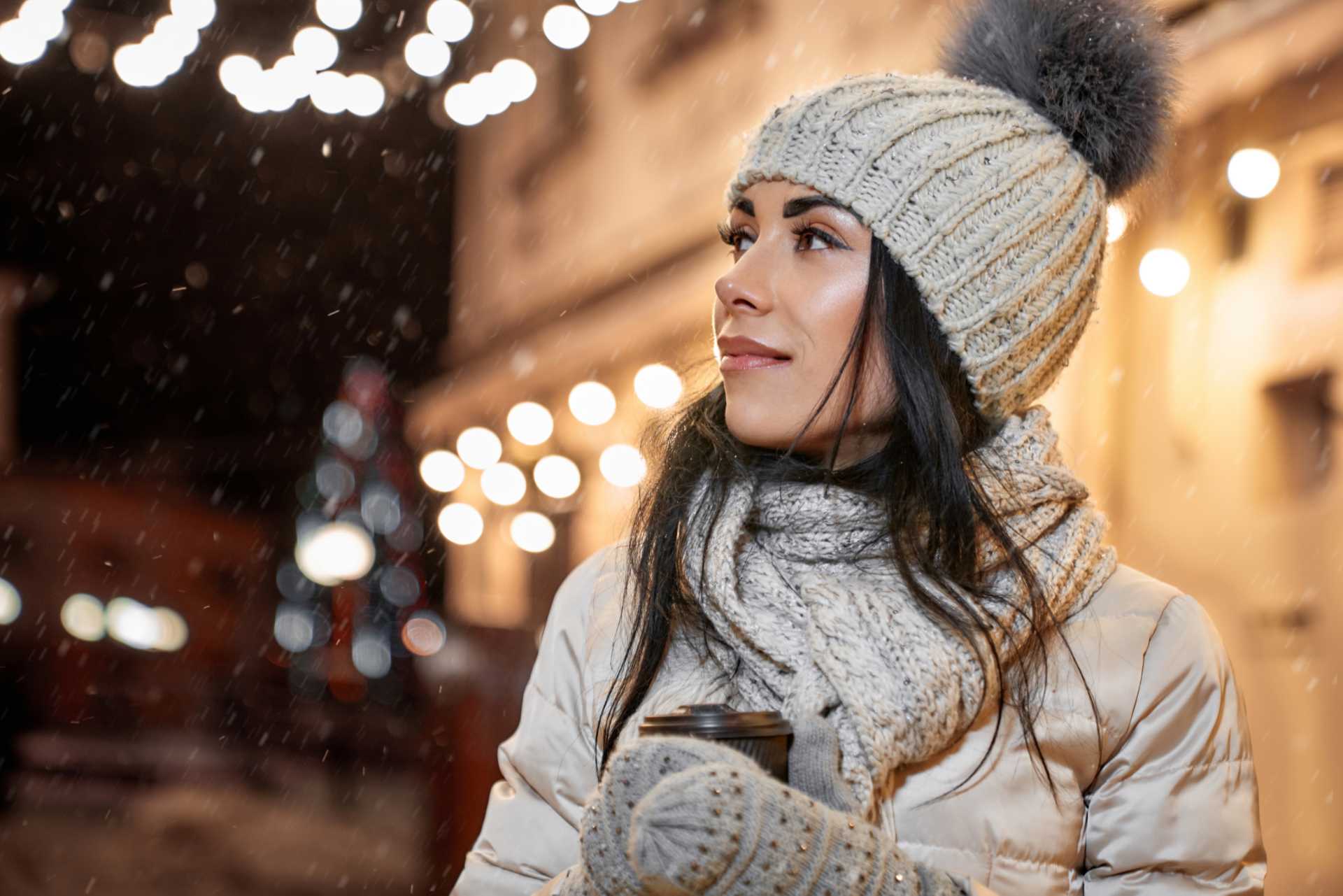 Winter Weather - Model in winter clothing with coffee cup posing.