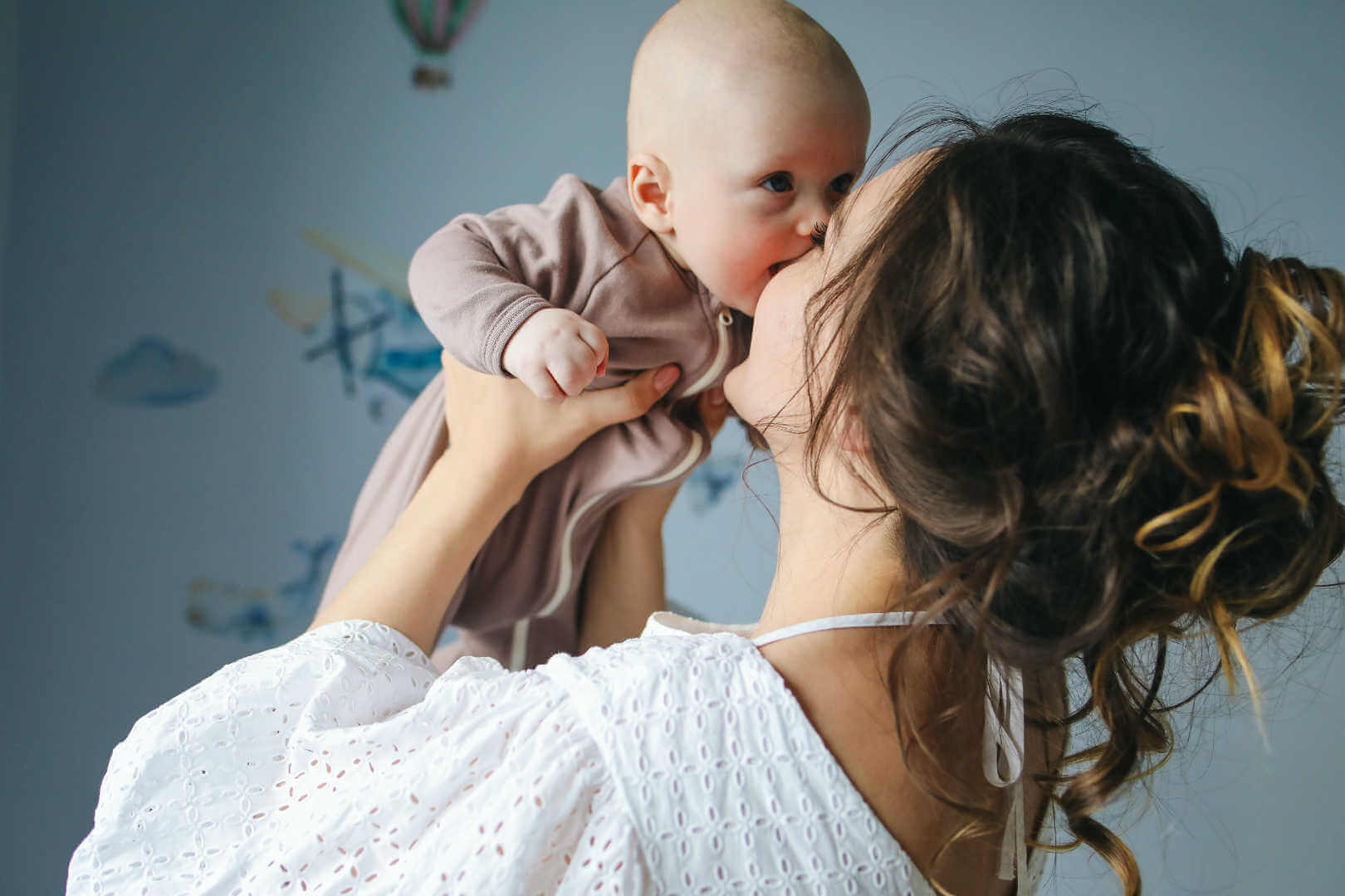 New Mom holding Baby up in her arms